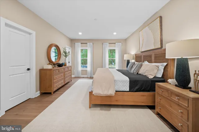 a spacious bedroom with a bed and a large window