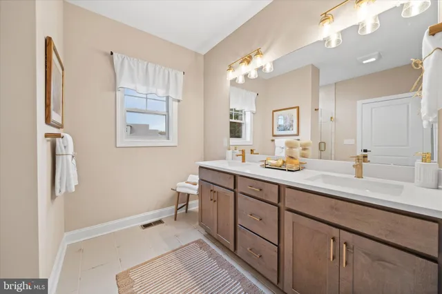 a spacious bathroom with a double vanity sink mirror and a toilet
