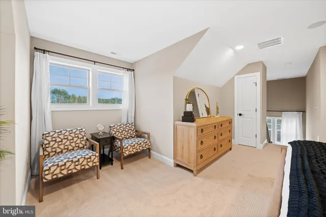 a bedroom with furniture and window