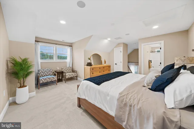 a bedroom with bed and a large window