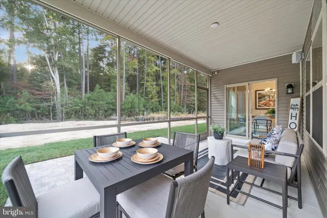 a view of a dining room with furniture wooden floor and garden view