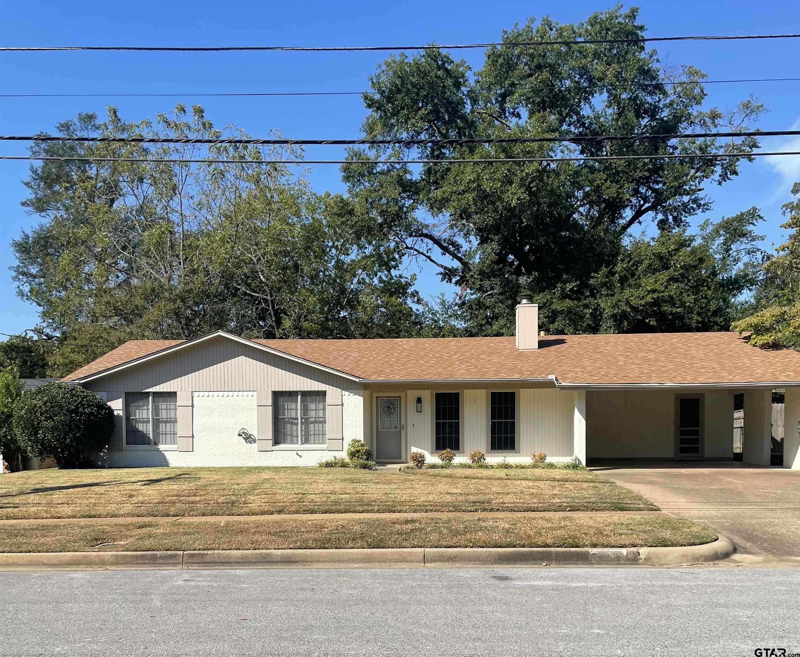 2523 Shenandoah Drive Tyler, TX 75701 - Photo 1 of 26 a front view of a house with a yard and garage