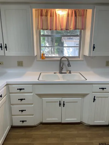 a kitchen with a cabinets window and a sink