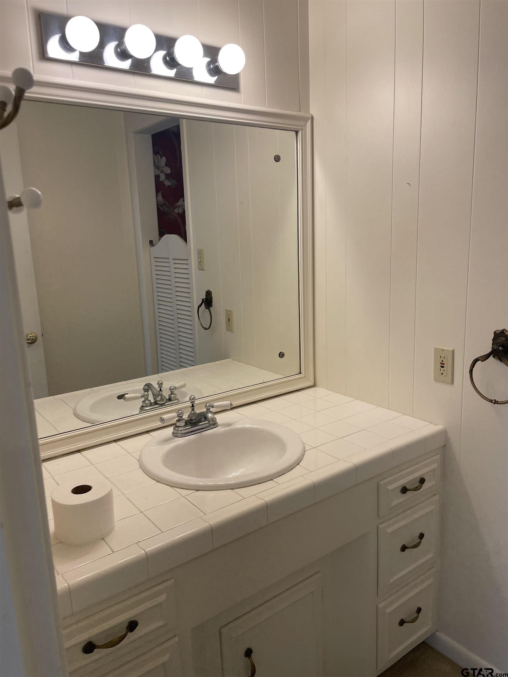 2523 Shenandoah Drive Tyler, TX 75701 - Photo 17 of 26 a bathroom with a sink and a mirror