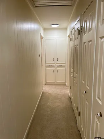 a view of a hallway with chandelier