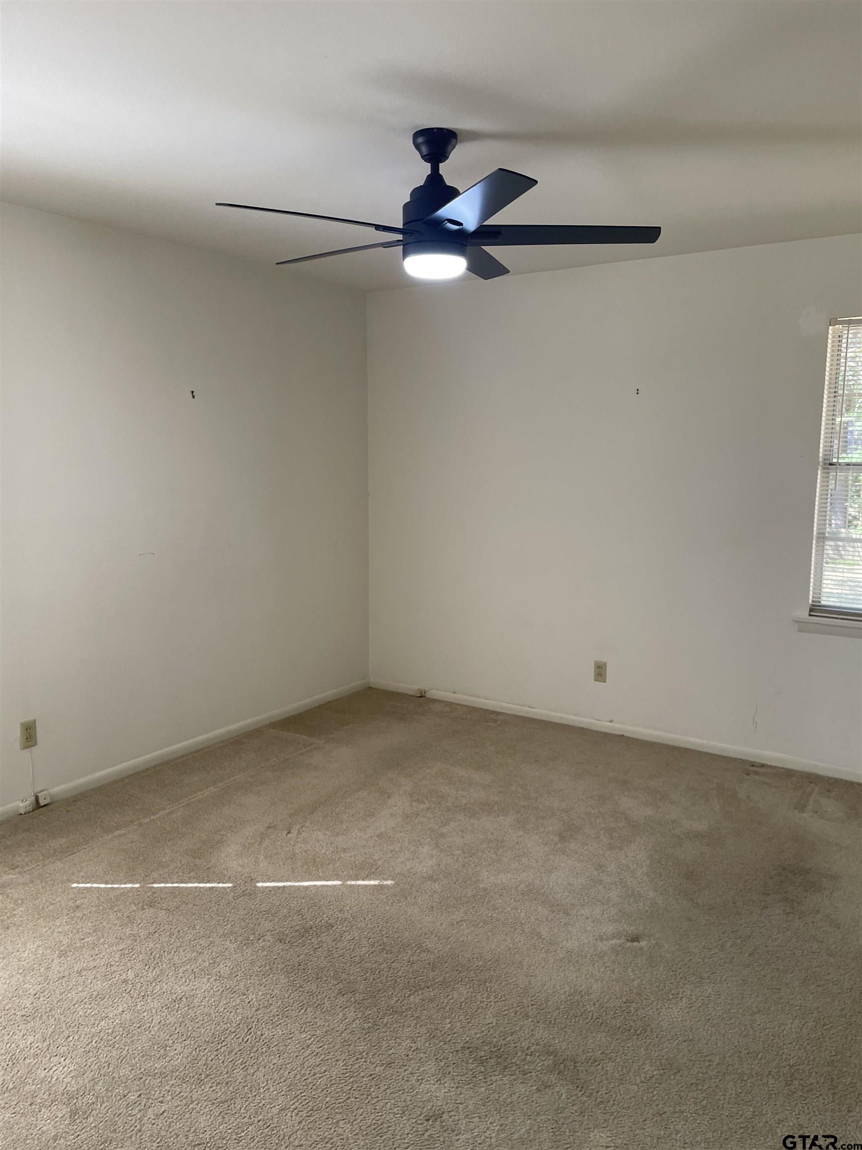 2523 Shenandoah Drive Tyler, TX 75701 - Photo 22 of 26 an empty room with windows and fan