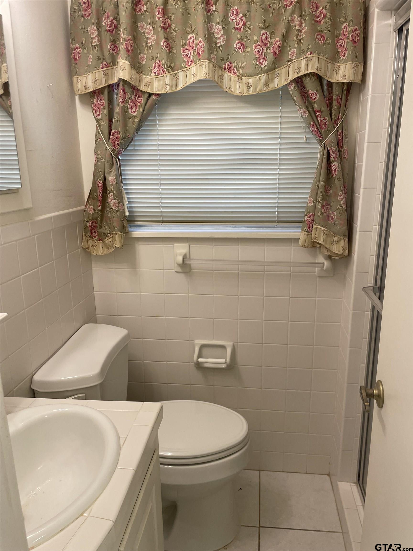 2523 Shenandoah Drive Tyler, TX 75701 - Photo 24 of 26 a bathroom with a toilet and a shower