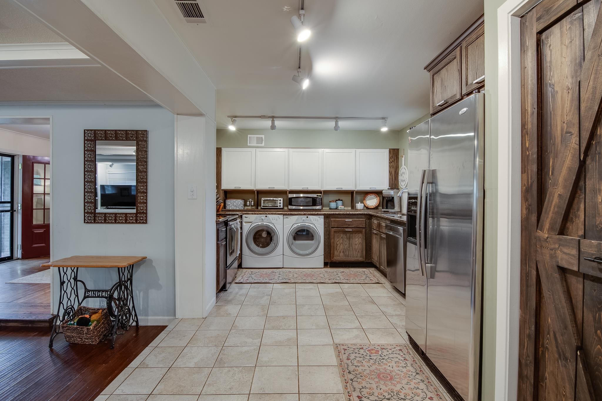 4898 Dee Road Memphis, TN 38117 - Photo 13 of 40 a kitchen with a stove a fridge and wooden floor
