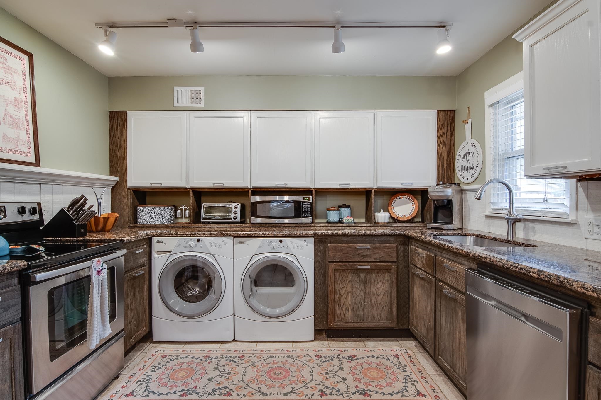 4898 Dee Road Memphis, TN 38117 - Photo 14 of 40 a kitchen with a stove top oven sink and cabinets
