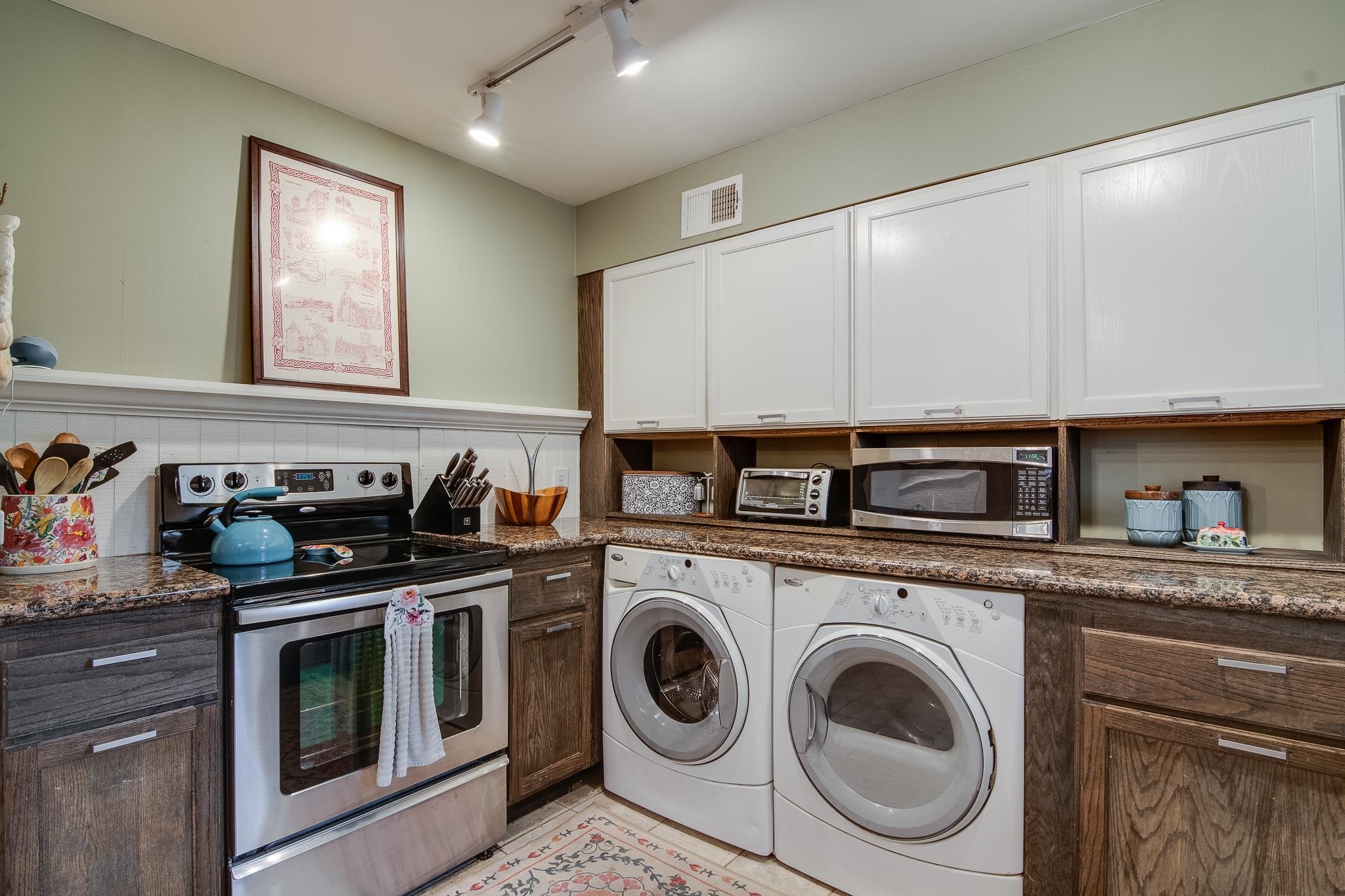 4898 Dee Road Memphis, TN 38117 - Photo 15 of 40 a kitchen with stainless steel appliances granite countertop a stove and a sink