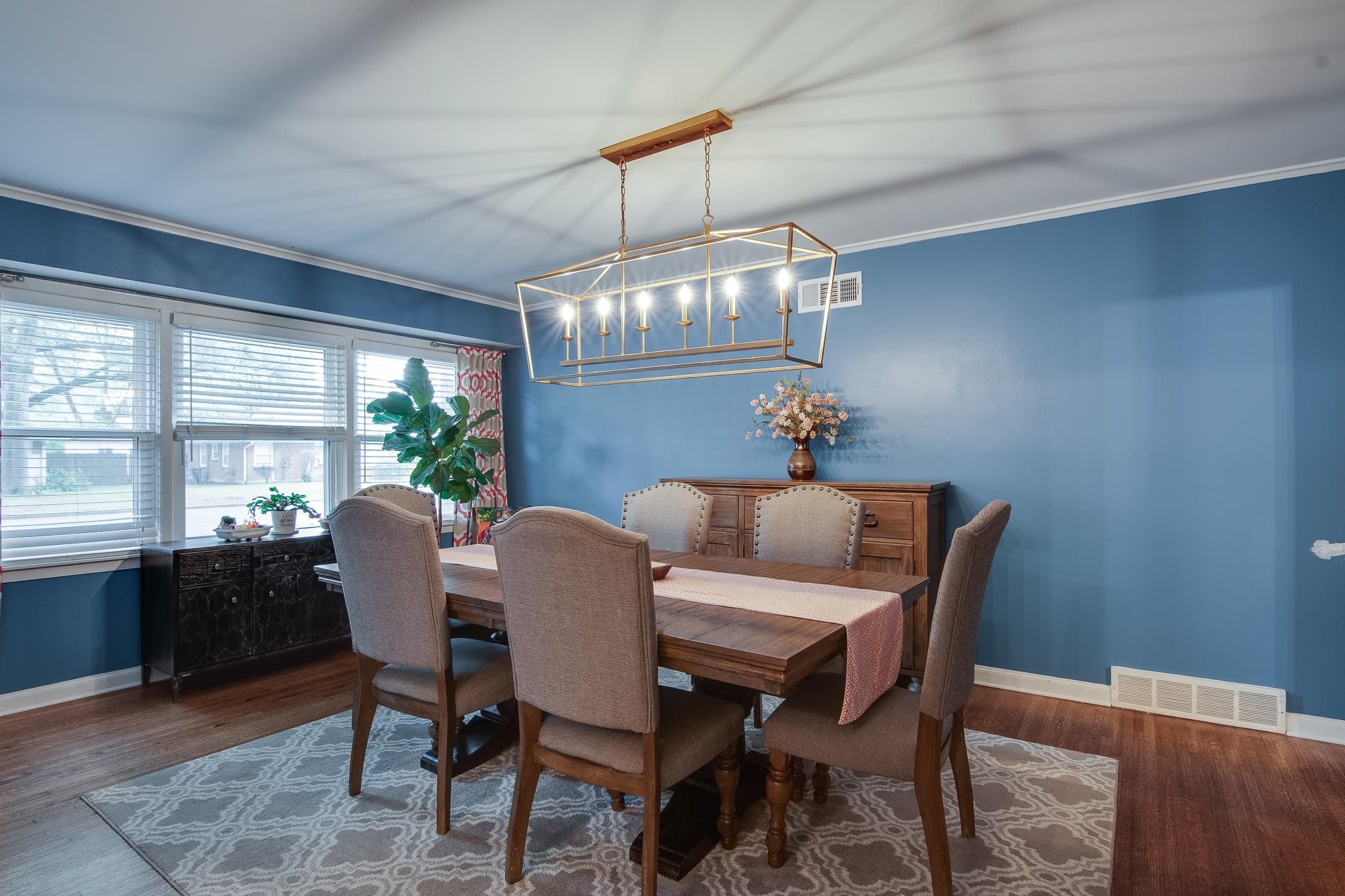4898 Dee Road Memphis, TN 38117 - Photo 21 of 40 a view of a dining room with furniture a chandelier and wooden floor