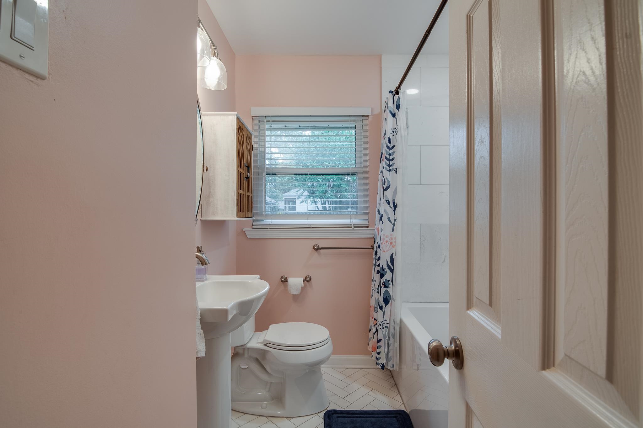 4898 Dee Road Memphis, TN 38117 - Photo 31 of 40 a bathroom with a granite countertop toilet a sink and a mirror