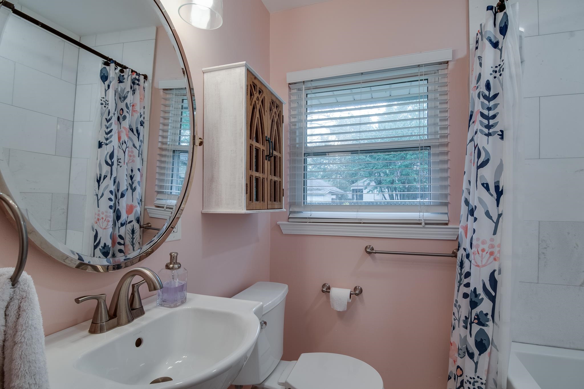 4898 Dee Road Memphis, TN 38117 - Photo 32 of 40 a bathroom with a sink and mirror with toilet
