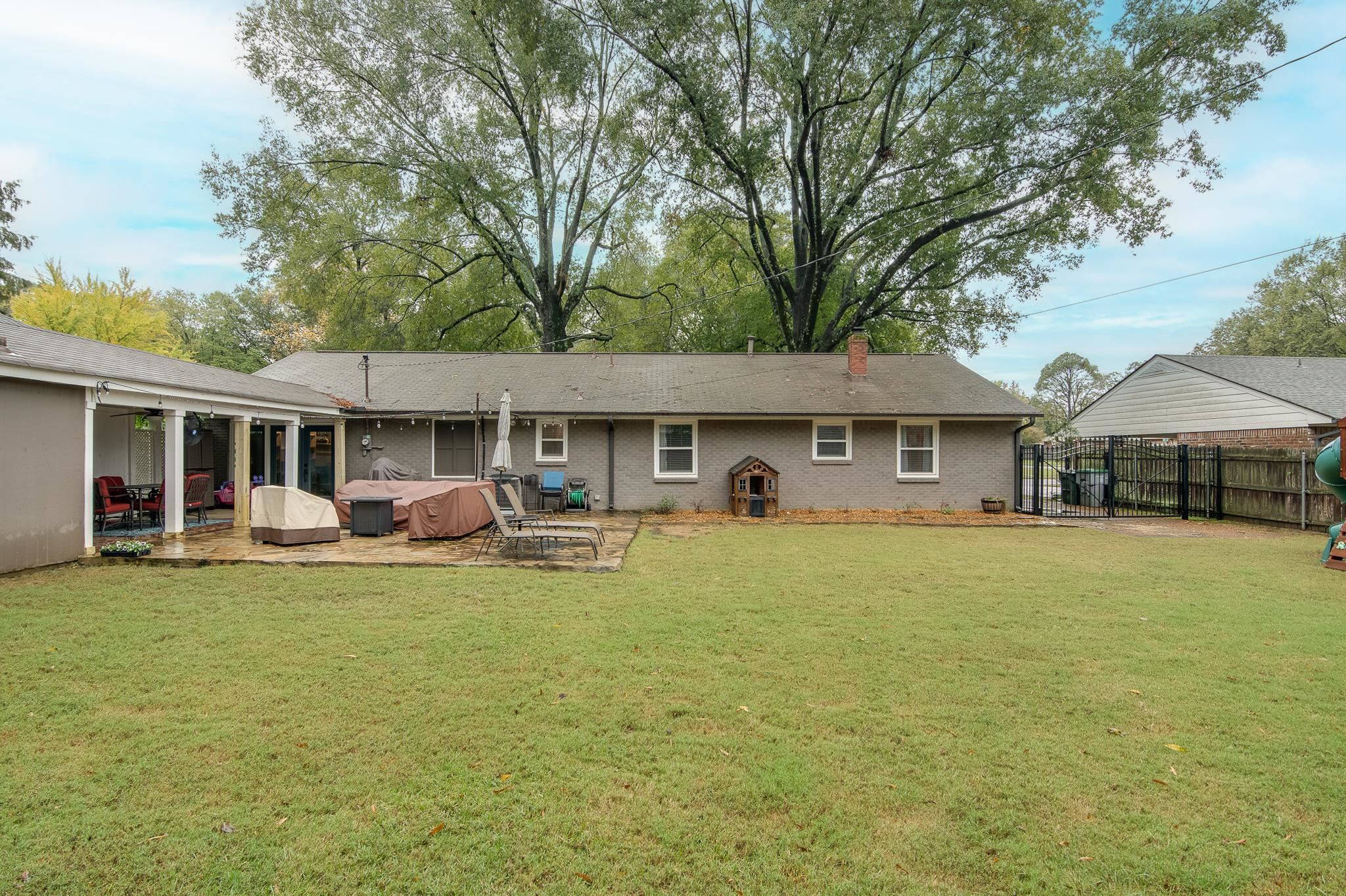 4898 Dee Road Memphis, TN 38117 - Photo 40 of 40 a front view of a house with a garden and porch