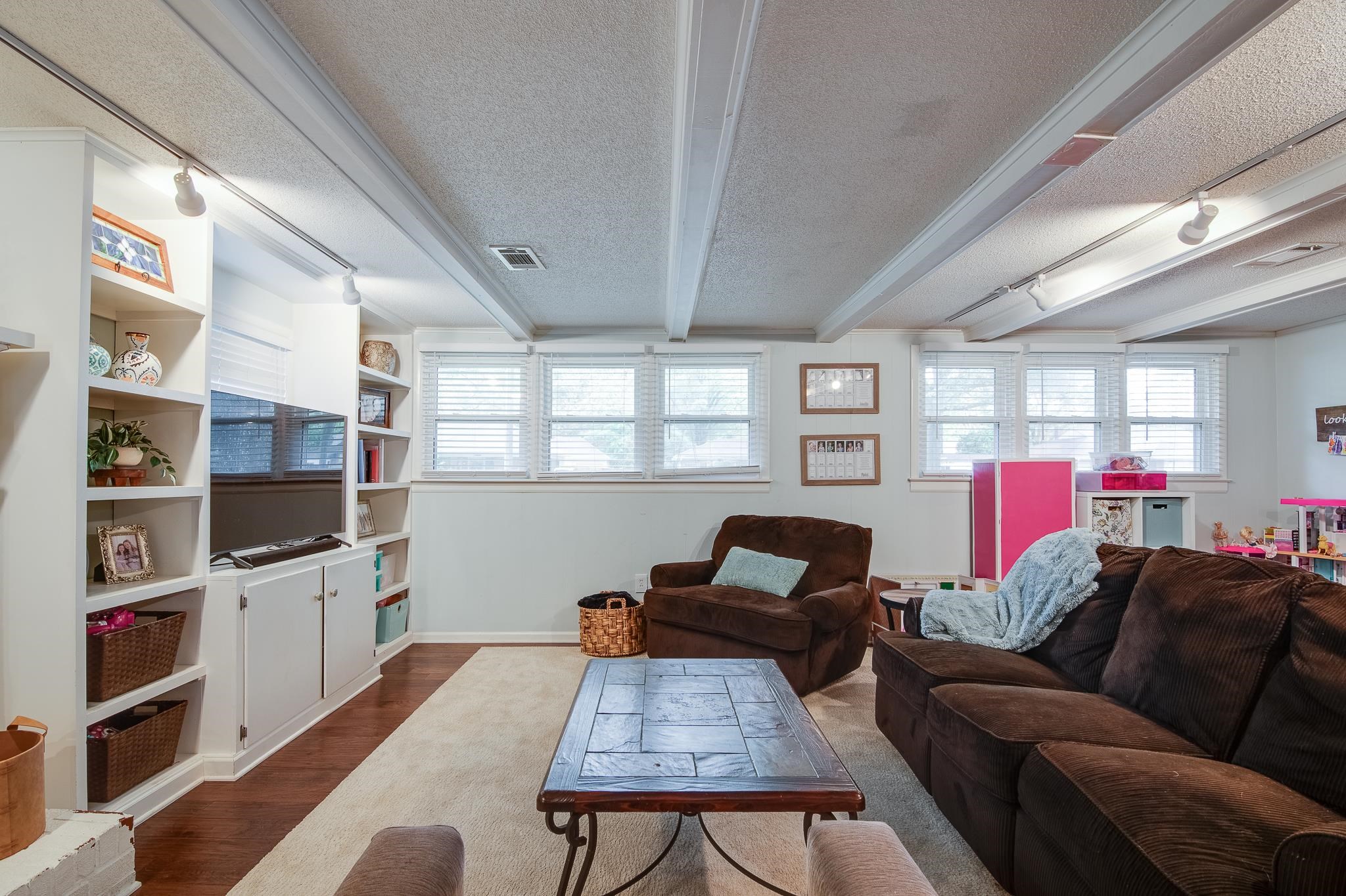 4898 Dee Road Memphis, TN 38117 - Photo 7 of 40 a living room with furniture a flat screen tv and a book shelf