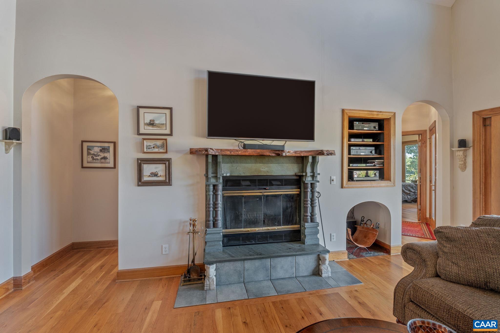 3535 Venable Road Kents Store, VA 23084 - Photo 13 of 75 a living room with furniture a flat screen tv and a fireplace