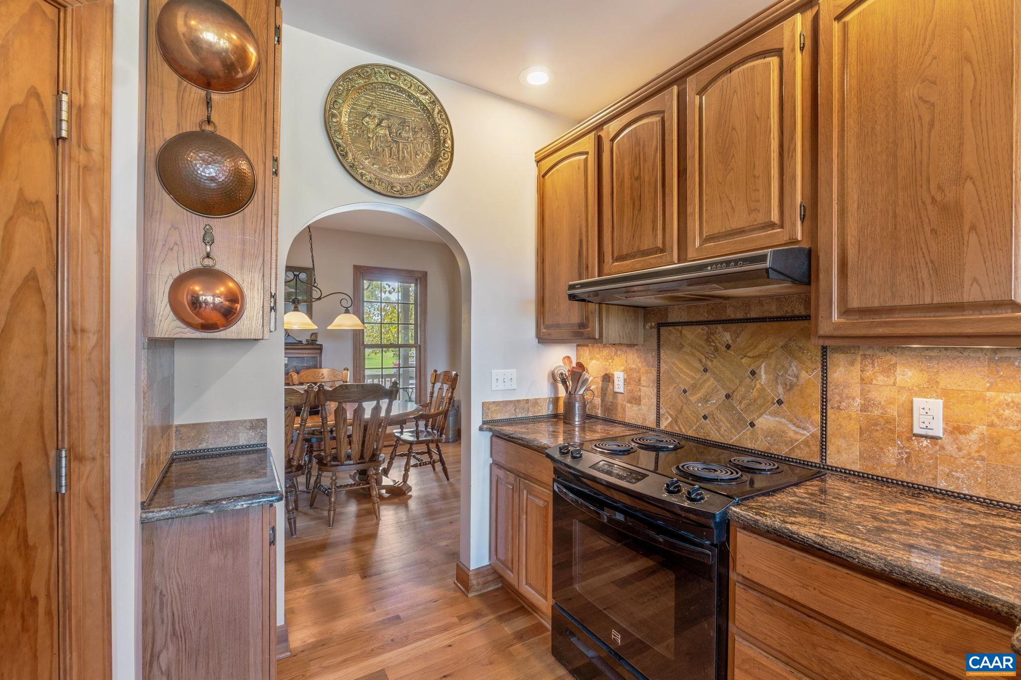 3535 Venable Road Kents Store, VA 23084 - Photo 17 of 75 a kitchen with stainless steel appliances granite countertop a stove and a wooden floor