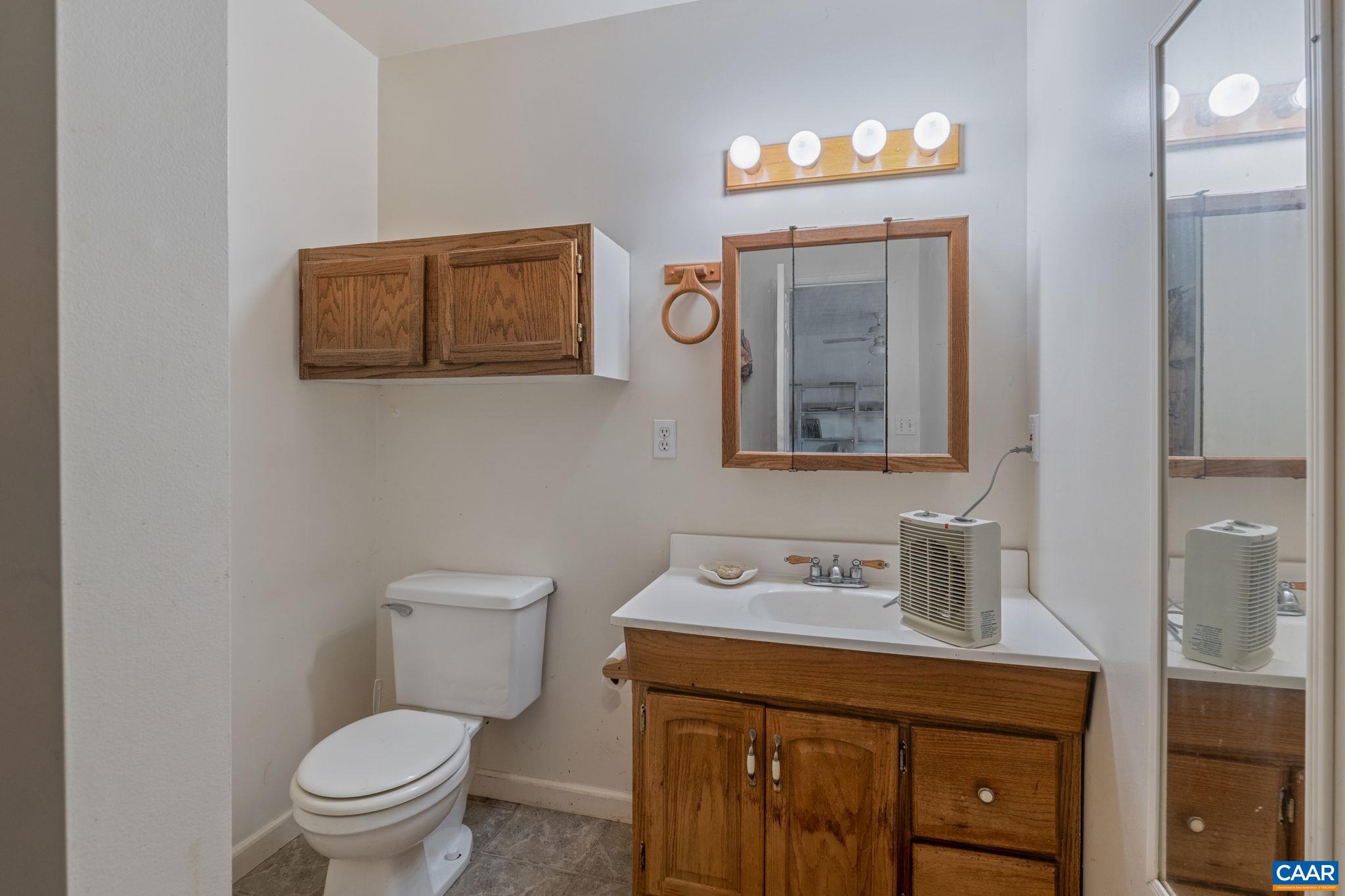 3535 Venable Road Kents Store, VA 23084 - Photo 50 of 75 a bathroom with a toilet a sink and mirror