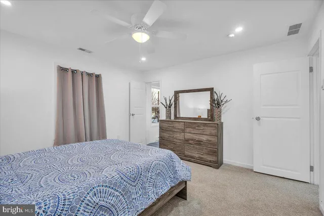 a bedroom with a bed and a dresser