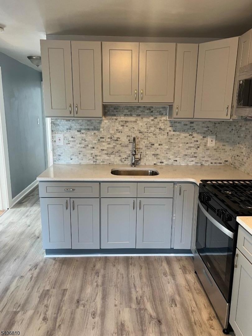 814 South 19th Street Newark, NJ 07108 - Photo 8 of 16 a kitchen with granite countertop cabinets and white appliances