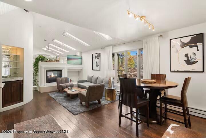 107 Aspen Mountain Road, Unit 9 Aspen, CO 81611 - Photo 2 of 19 a living room with furniture a fireplace and a large window