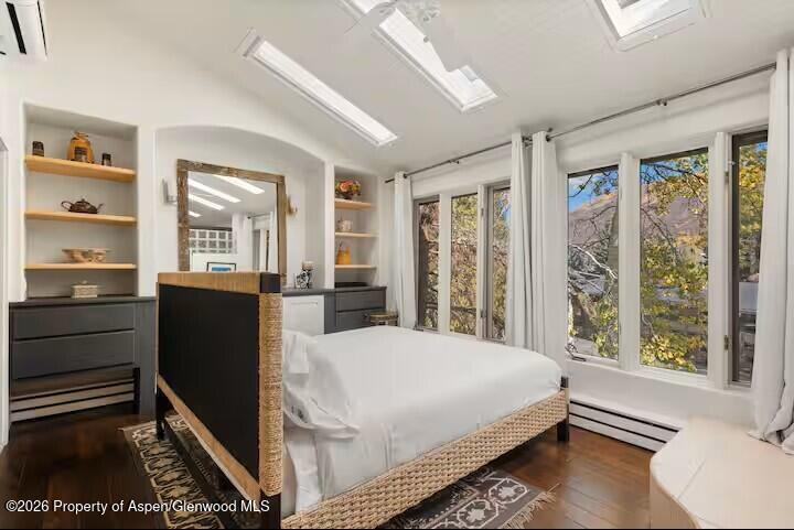 107 Aspen Mountain Road, Unit 9 Aspen, CO 81611 - Photo 7 of 19 a bedroom with a bed and wooden floor