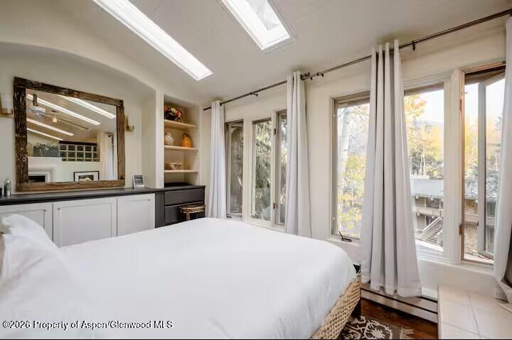 107 Aspen Mountain Road, Unit 9 Aspen, CO 81611 - Photo 8 of 19 a bedroom with a large bed and a large window