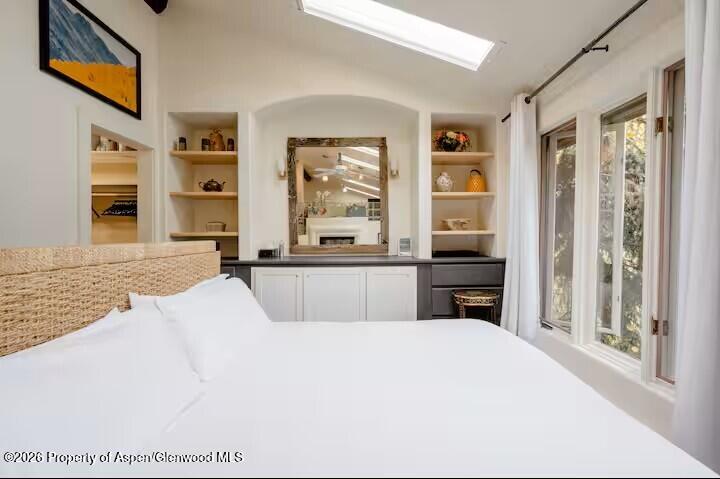 107 Aspen Mountain Road, Unit 9 Aspen, CO 81611 - Photo 9 of 19 a kitchen with stainless steel appliances a refrigerator a stove and a sink with wooden floor