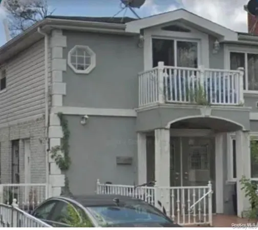 a front view of a house with parking space