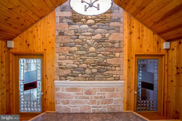 a view of a patio with couches table and chairs and wooden floor