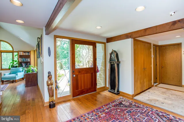 a living room with furniture a fireplace and a large window
