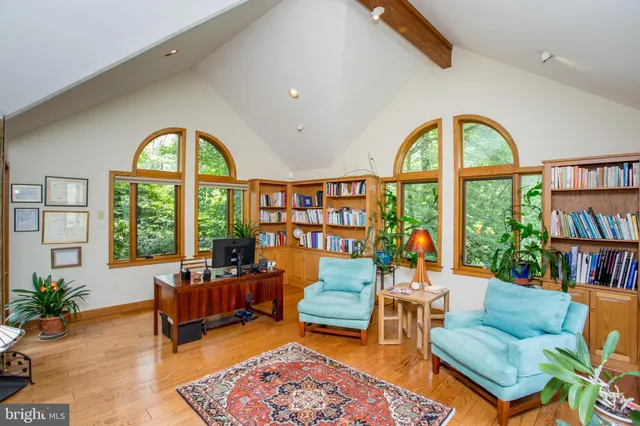 a kitchen that has a sink a stove and chairs