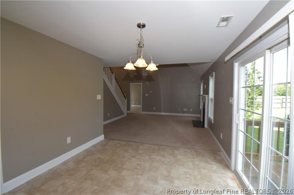 131 South Prince Henry Way Cameron, NC 28326 - Photo 6 of 26 a view of a livingroom with a chandelier staircase and a large window