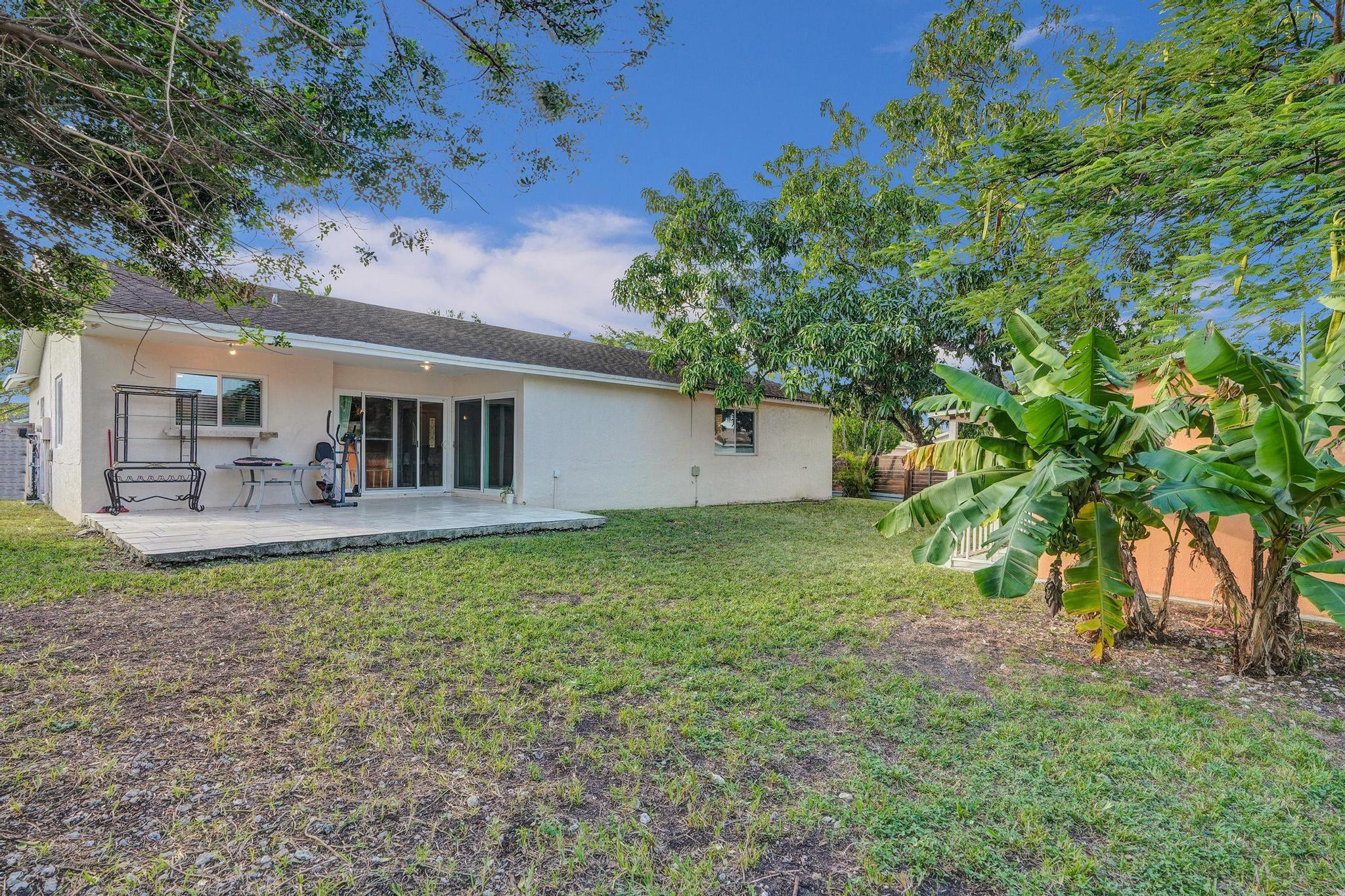 26205 Southwest 133rd Court Homestead, FL 33032 - Photo 12 of 45 a backyard of a house with table and chairs