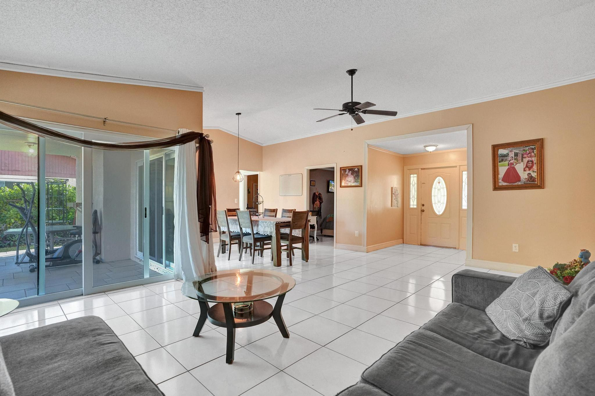 26205 Southwest 133rd Court Homestead, FL 33032 - Photo 17 of 45 a living room with furniture and a glass door