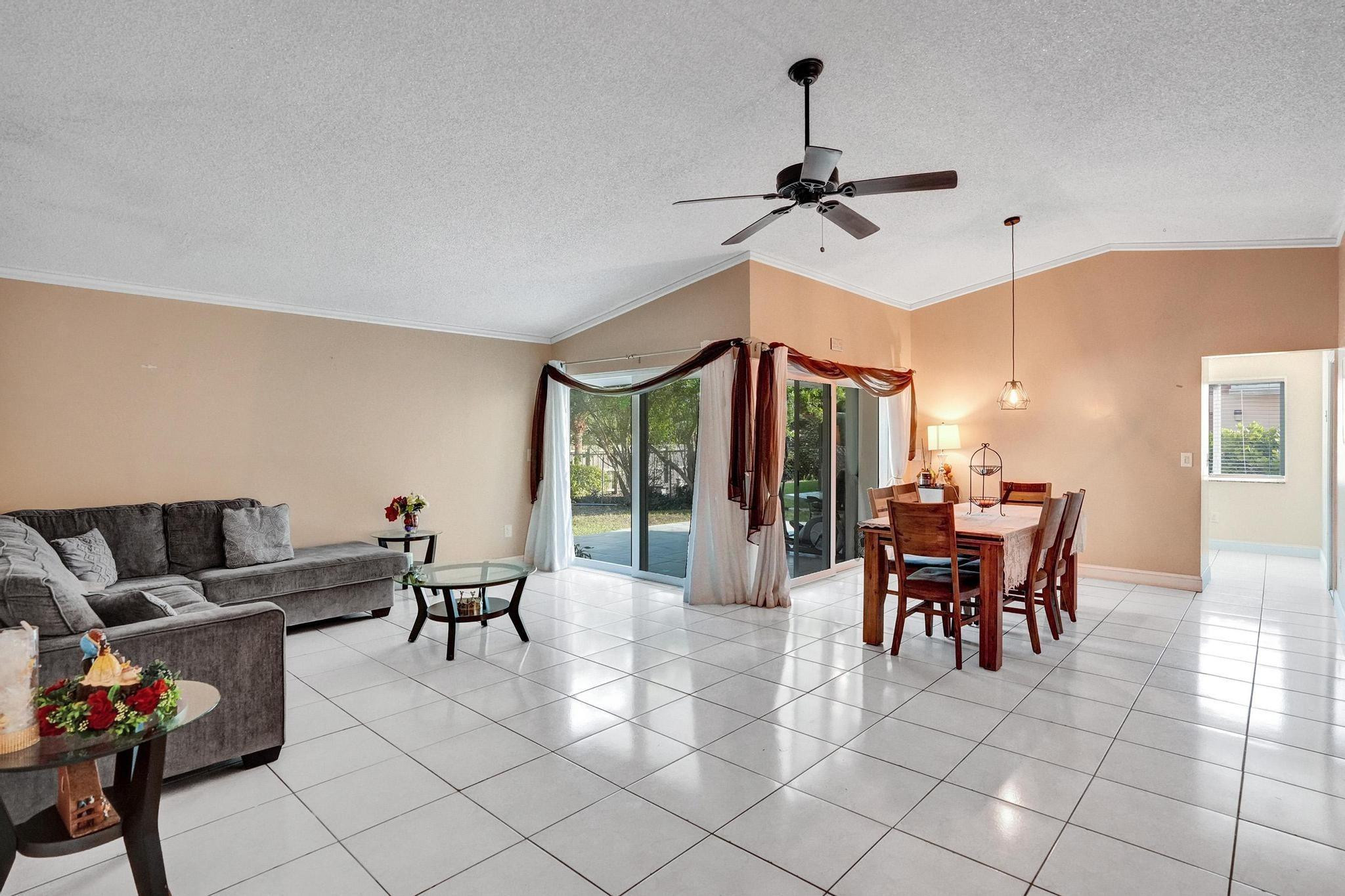 26205 Southwest 133rd Court Homestead, FL 33032 - Photo 18 of 45 a dining room with furniture a chandelier and window