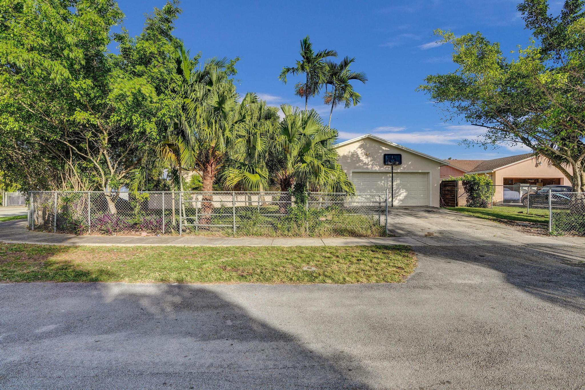 26205 Southwest 133rd Court Homestead, FL 33032 - Photo 2 of 45 a front view of a house with a yard