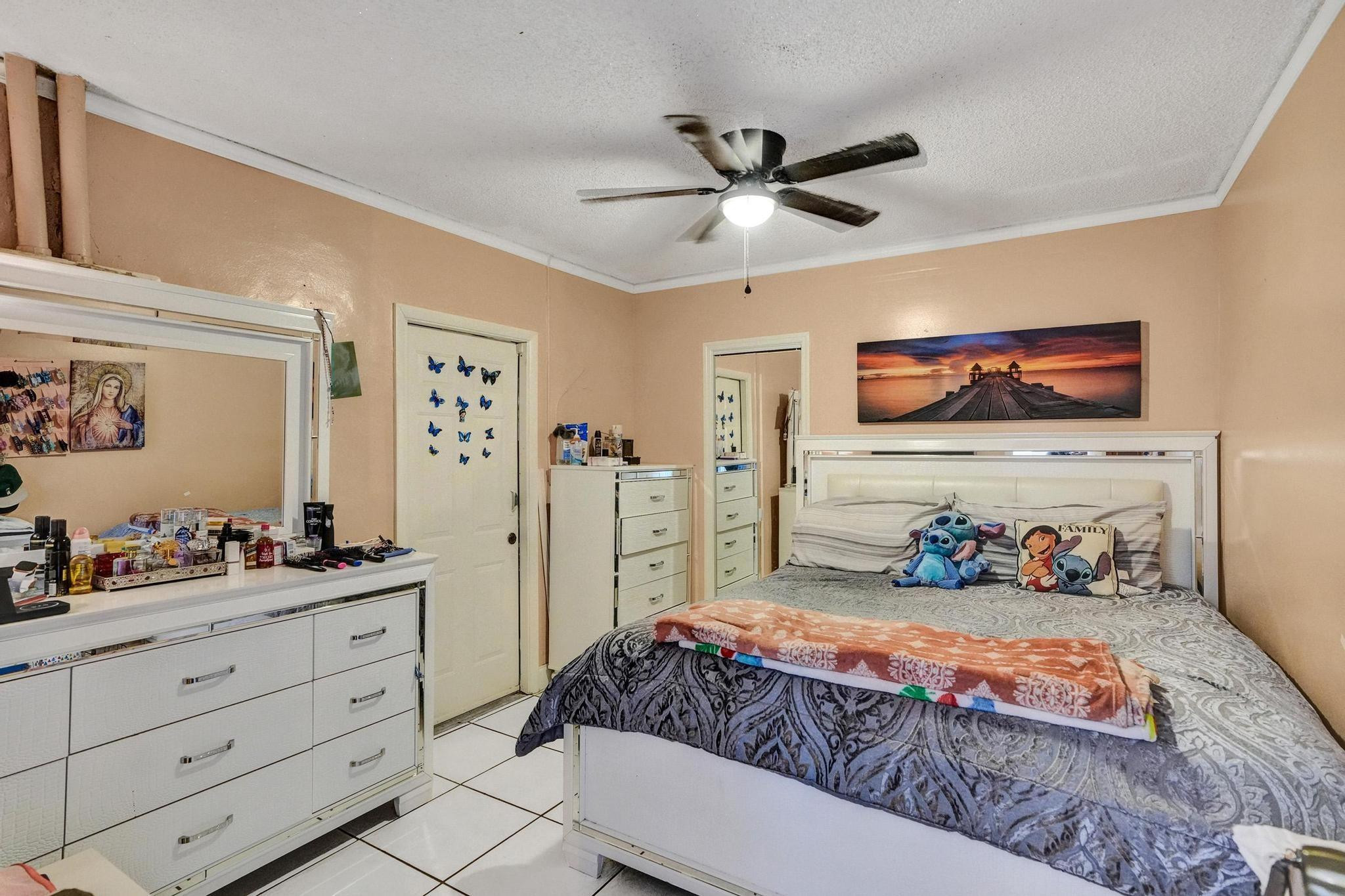 26205 Southwest 133rd Court Homestead, FL 33032 - Photo 27 of 45 a bedroom with a bed and a chandelier