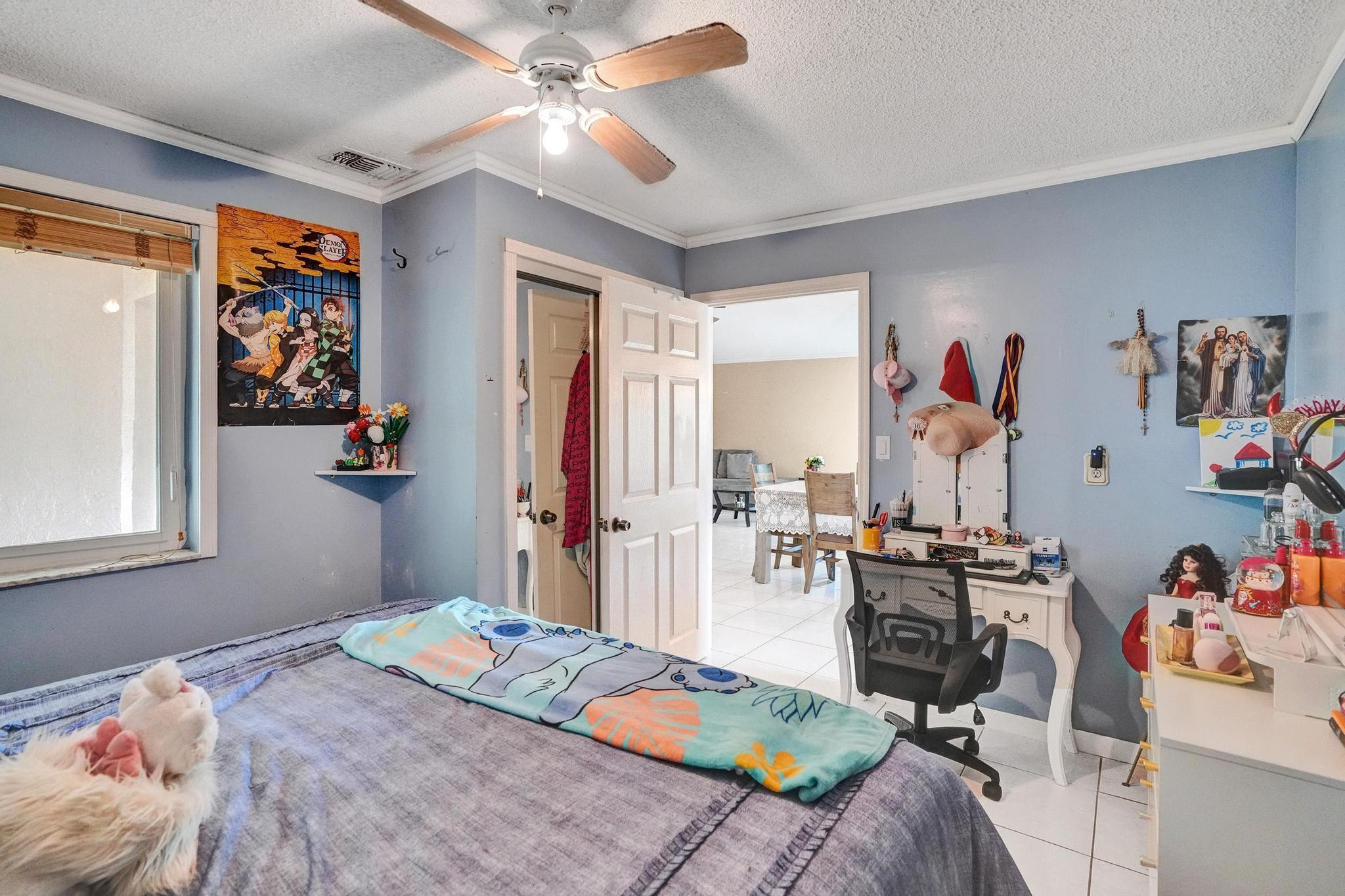 26205 Southwest 133rd Court Homestead, FL 33032 - Photo 28 of 45 a bedroom that has a bed and a chandelier