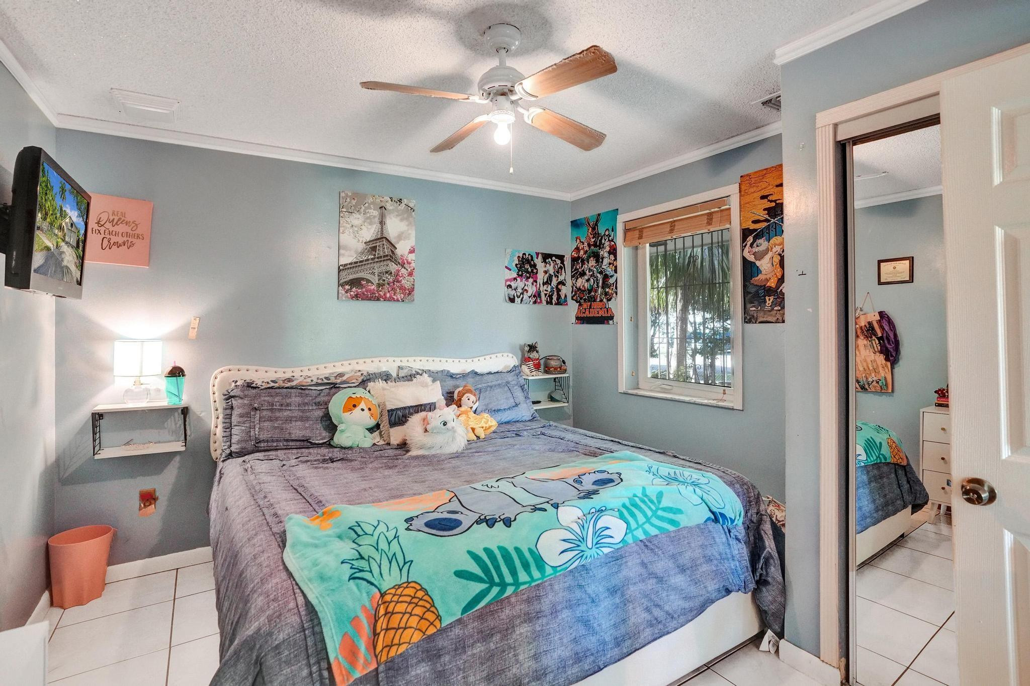 26205 Southwest 133rd Court Homestead, FL 33032 - Photo 29 of 45 a bedroom that has a bed and a chandelier
