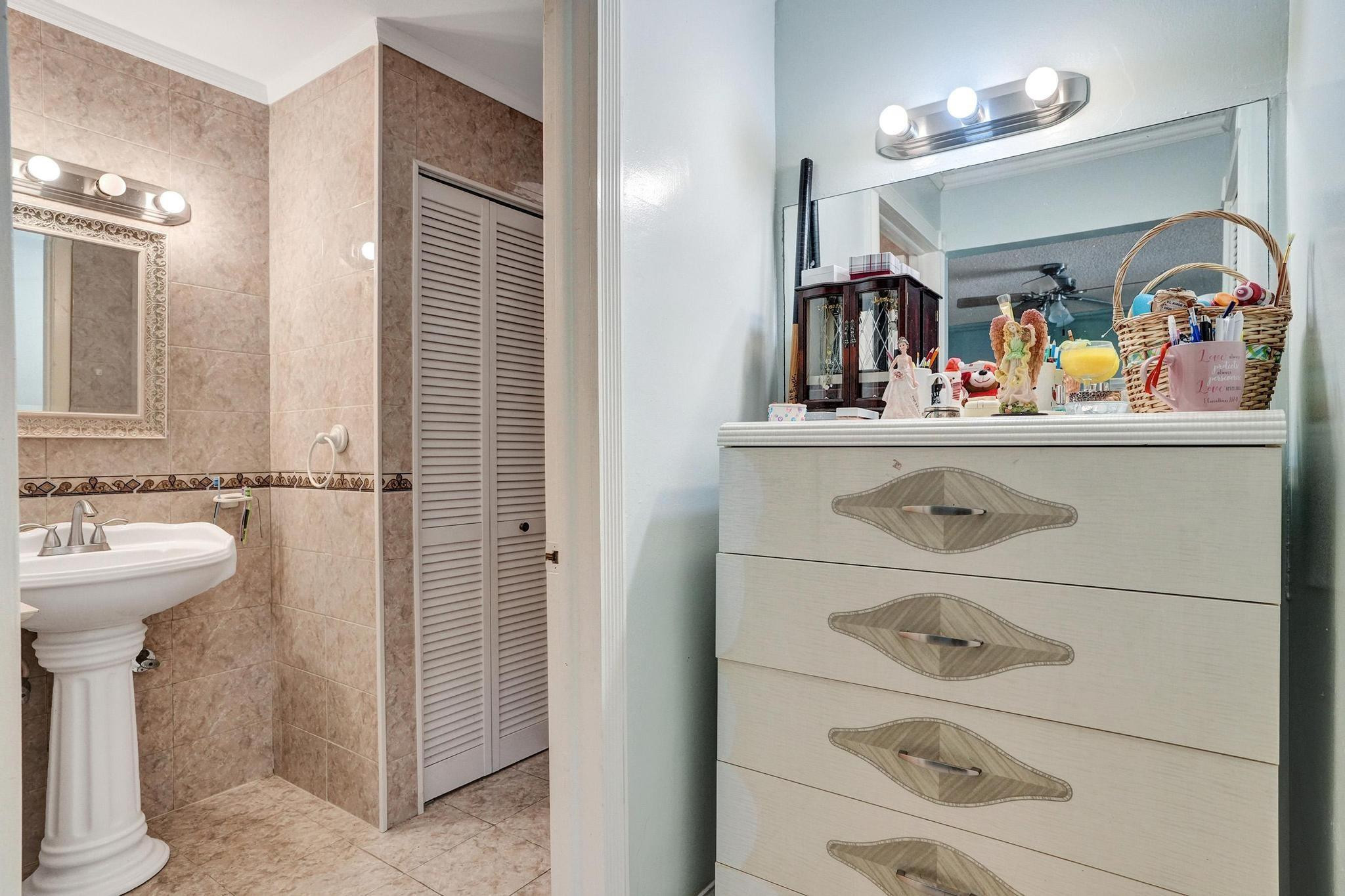26205 Southwest 133rd Court Homestead, FL 33032 - Photo 36 of 45 a bathroom with a sink a mirror and vanity