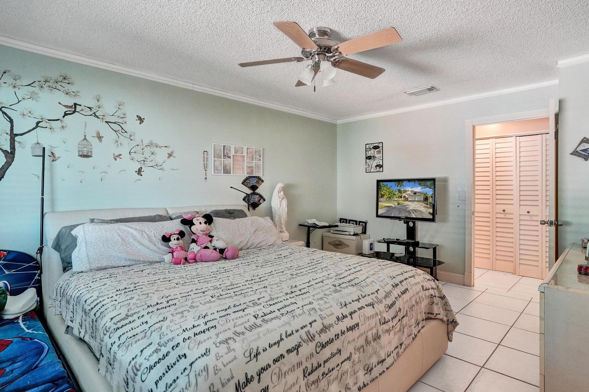26205 Southwest 133rd Court Homestead, FL 33032 - Photo 38 of 45 a bedroom with a bed and a flat screen tv