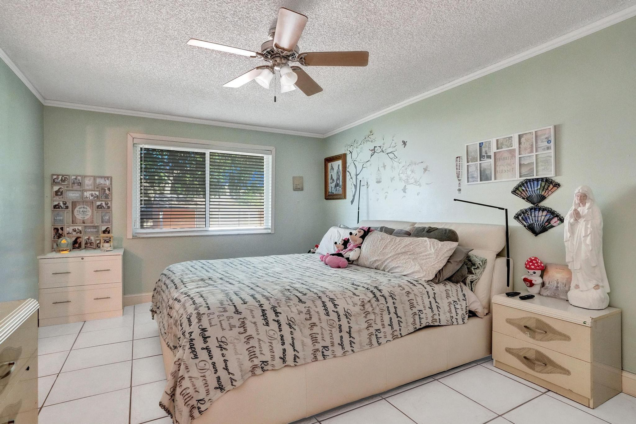 26205 Southwest 133rd Court Homestead, FL 33032 - Photo 39 of 45 a bedroom with a bed and a chandelier