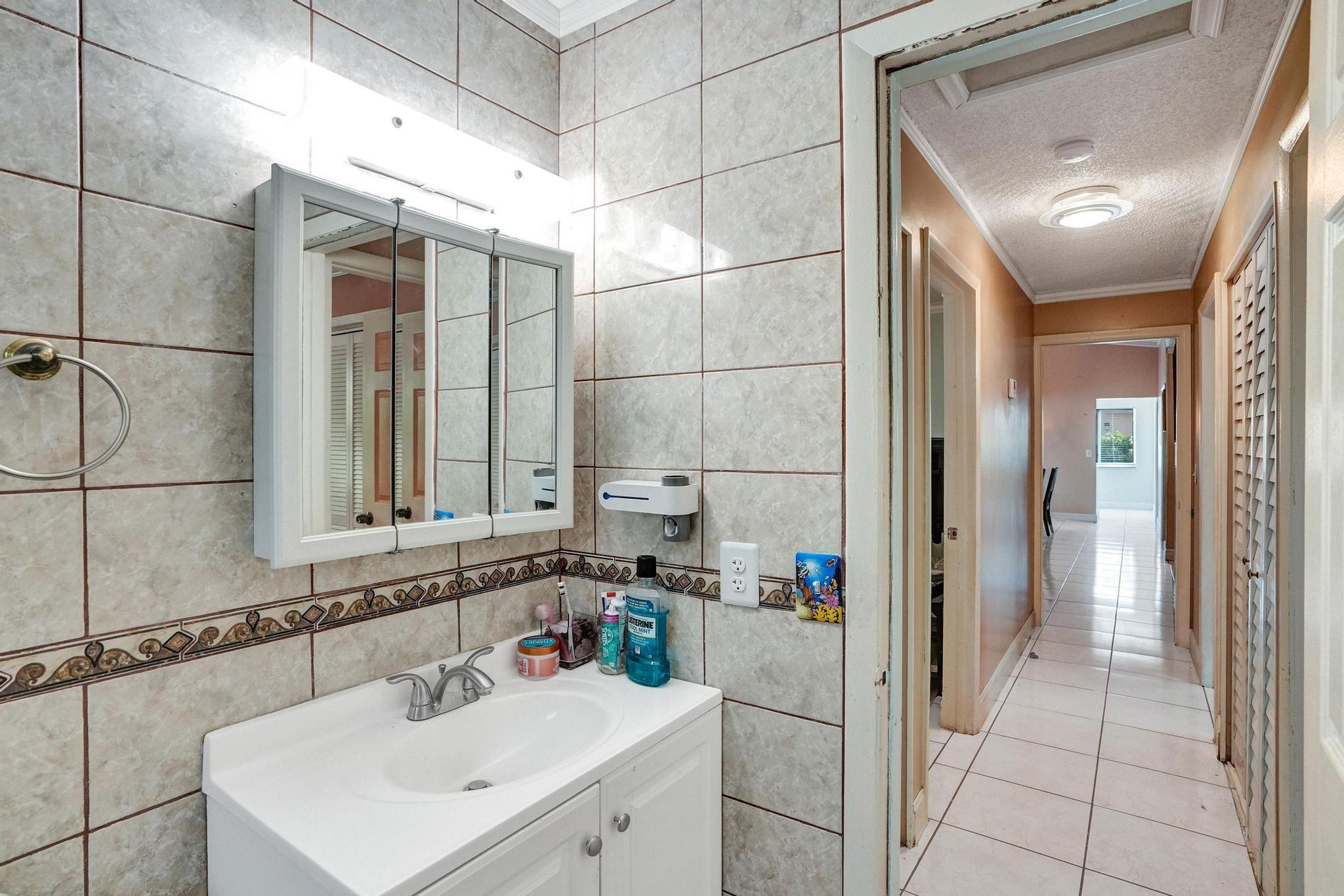 26205 Southwest 133rd Court Homestead, FL 33032 - Photo 40 of 45 a bathroom with a sink and a mirror