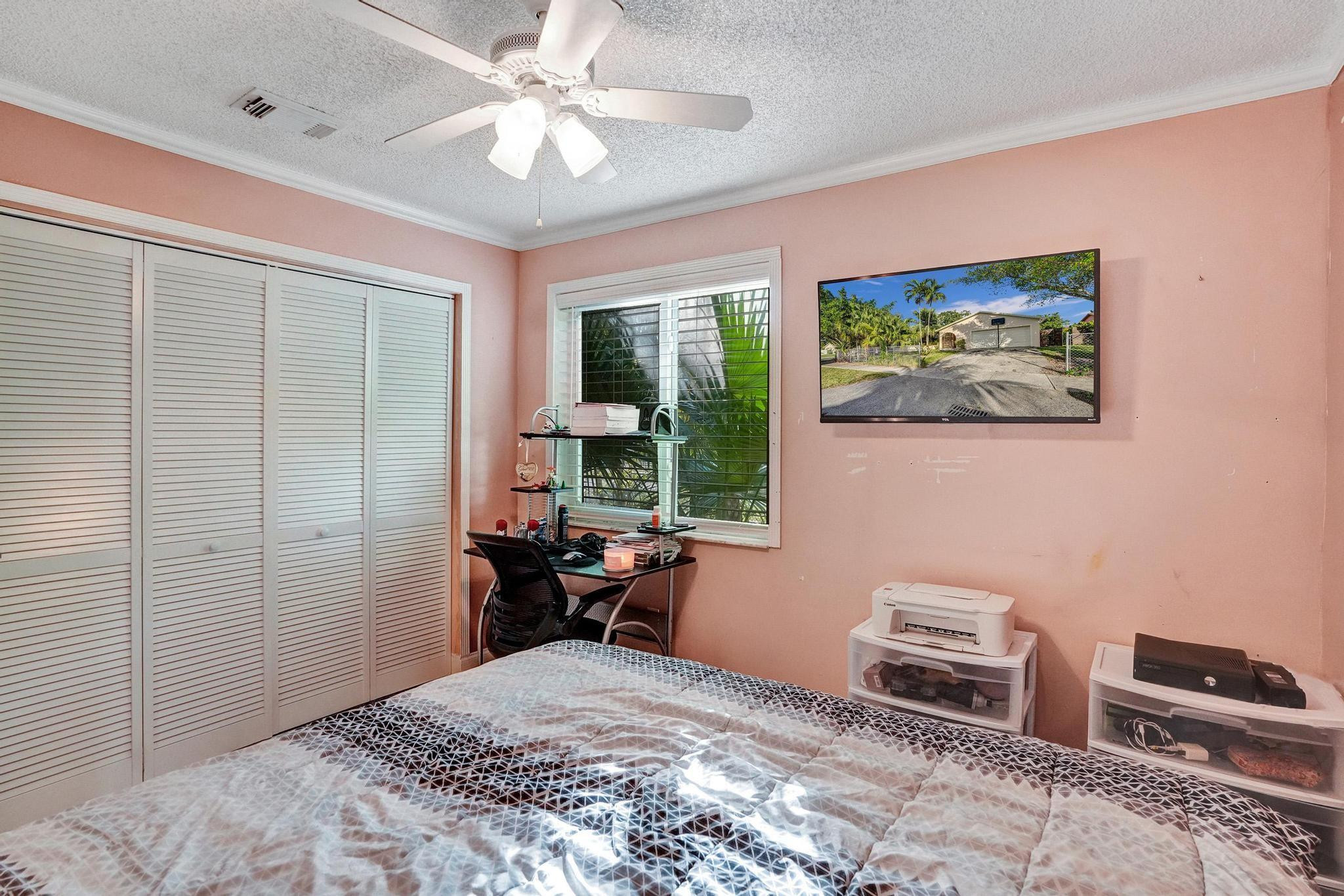26205 Southwest 133rd Court Homestead, FL 33032 - Photo 42 of 45 a bedroom with a bed dresser and a window