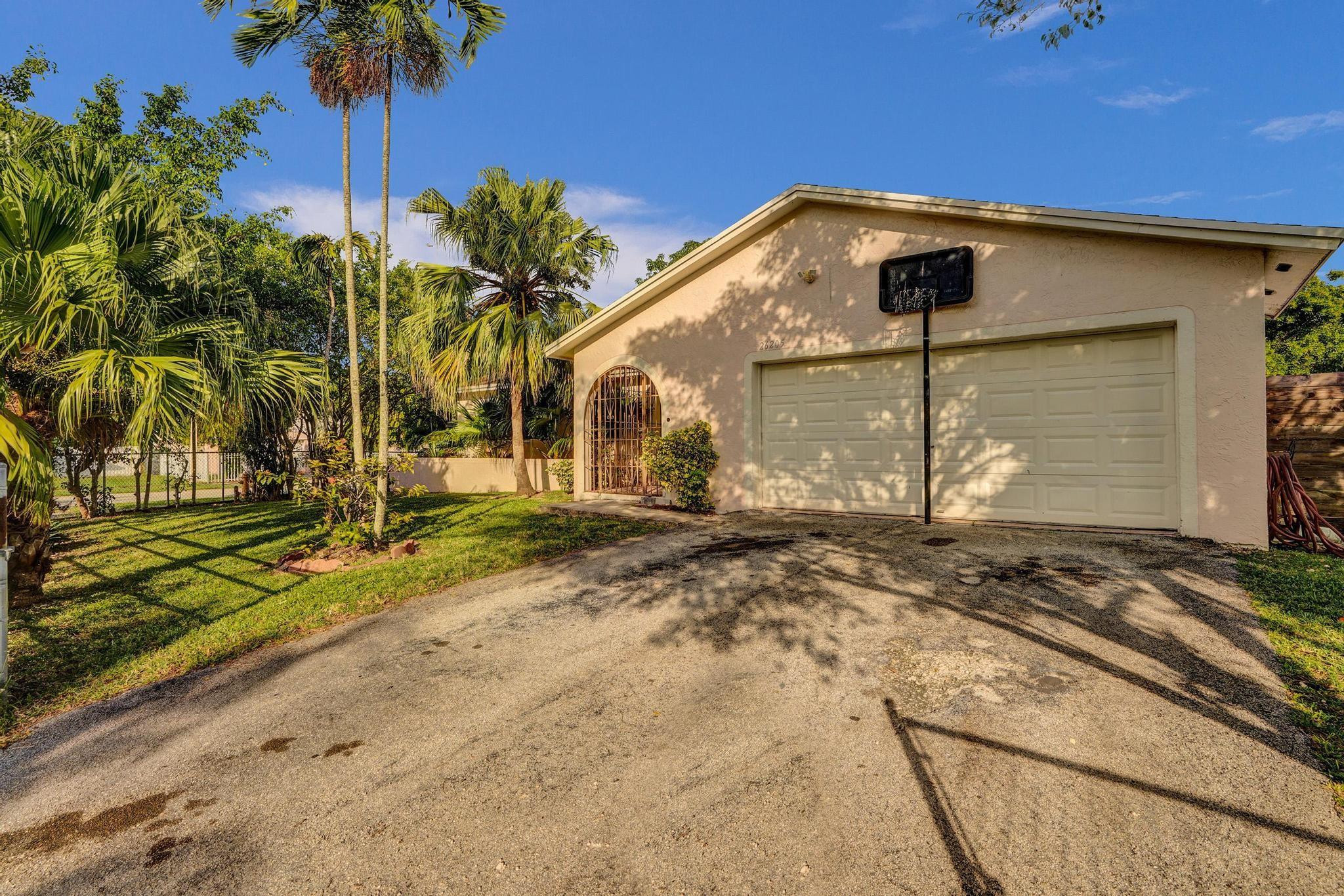 26205 Southwest 133rd Court Homestead, FL 33032 - Photo 7 of 45 a front view of a house with a yard