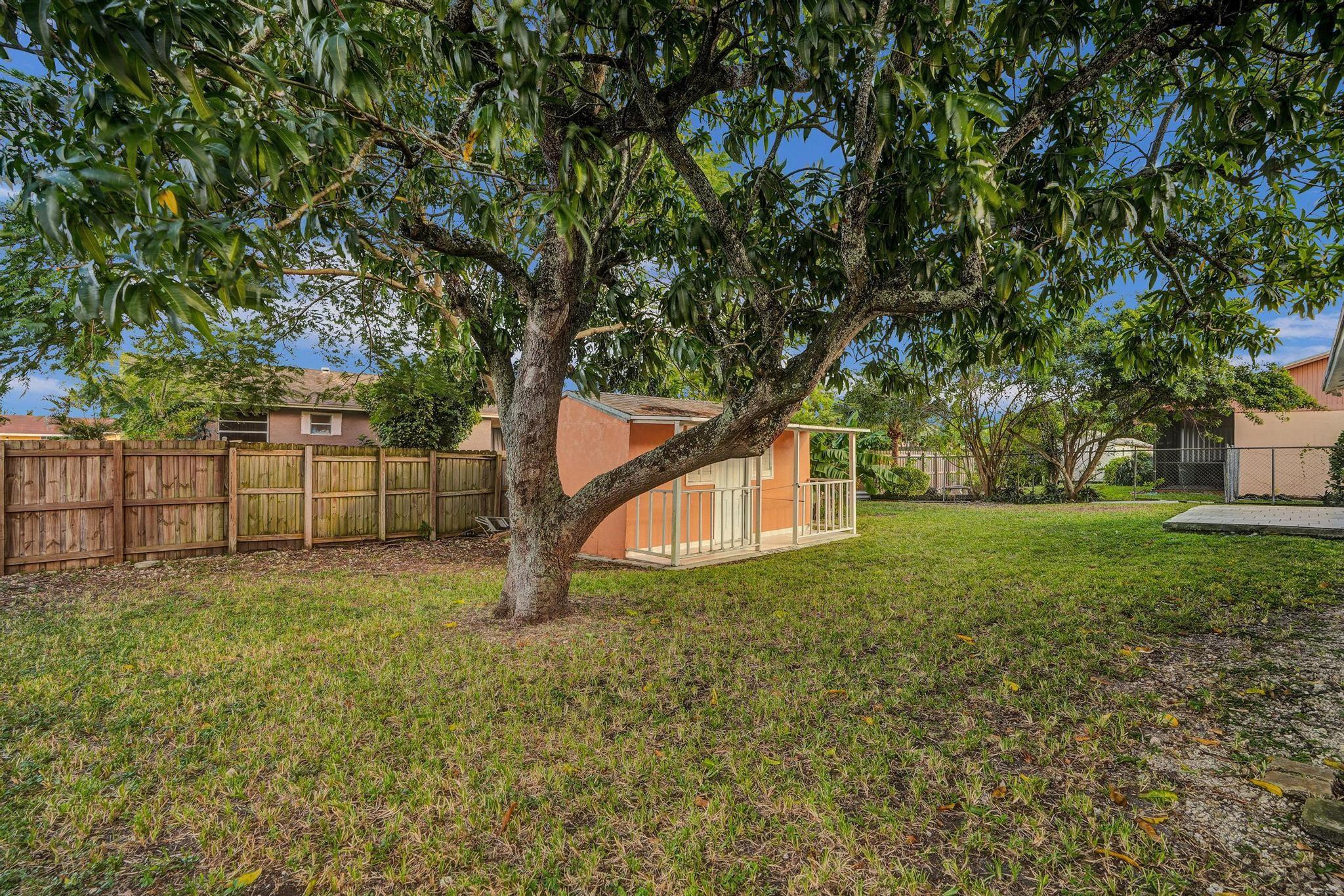 26205 Southwest 133rd Court Homestead, FL 33032 - Photo 9 of 45 a view of a yard with a house and trees