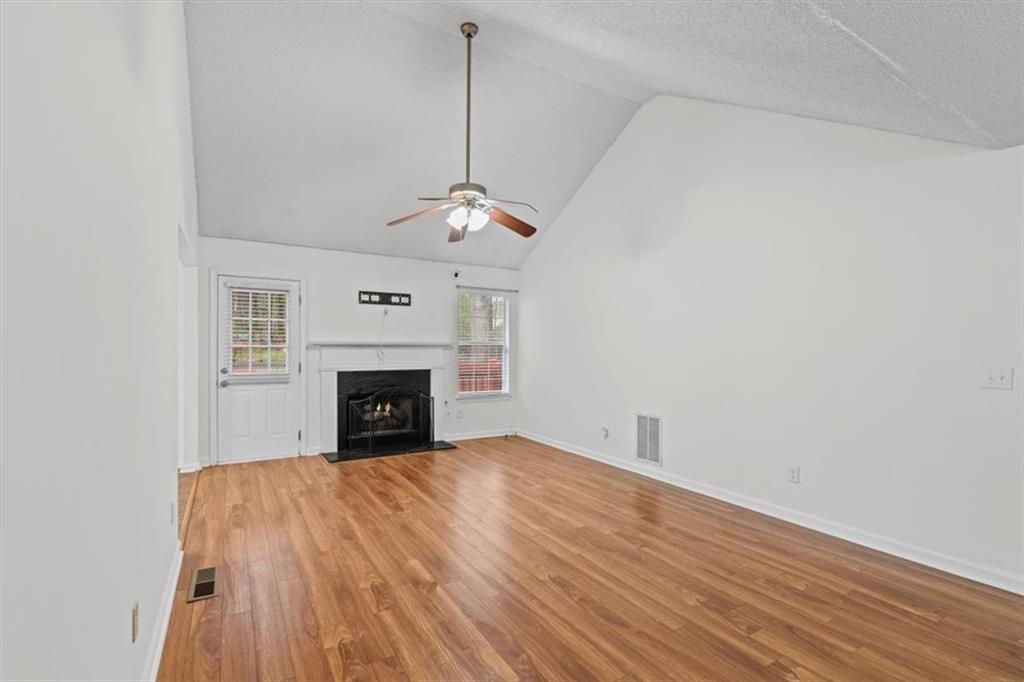 2242 Rocksram Court Buford, GA 30519 - Photo 11 of 52 a view of an empty room with wooden floor fireplace and a window
