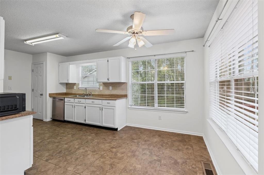 2242 Rocksram Court Buford, GA 30519 - Photo 14 of 52 a kitchen with a refrigerator a sink and cabinets