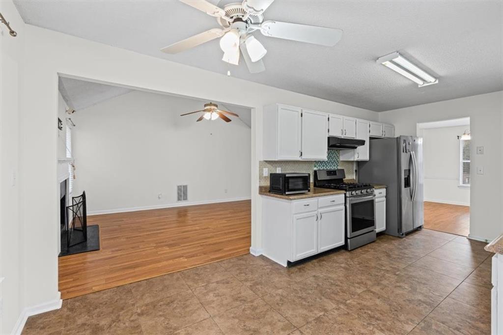 2242 Rocksram Court Buford, GA 30519 - Photo 15 of 52 a kitchen with a refrigerator and a stove top oven